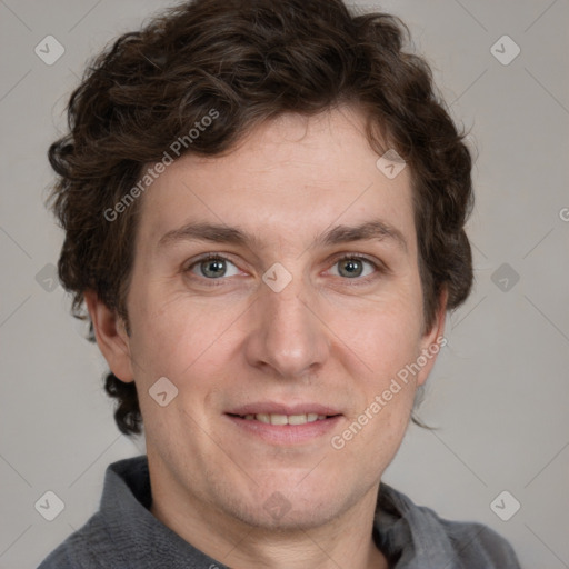 Joyful white adult male with short  brown hair and grey eyes