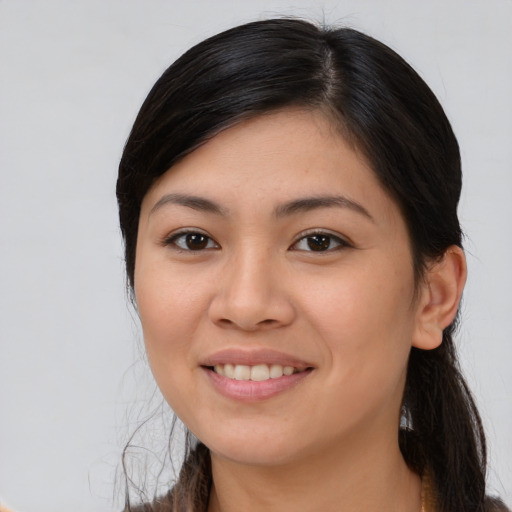 Joyful asian young-adult female with long  brown hair and brown eyes