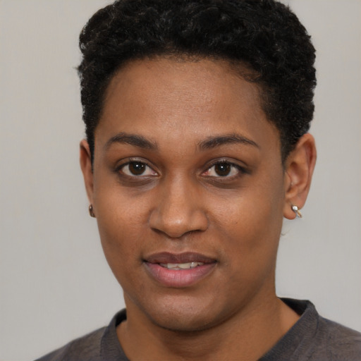 Joyful black young-adult female with short  brown hair and brown eyes