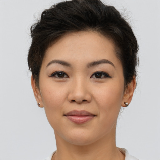 Joyful asian young-adult female with short  brown hair and brown eyes