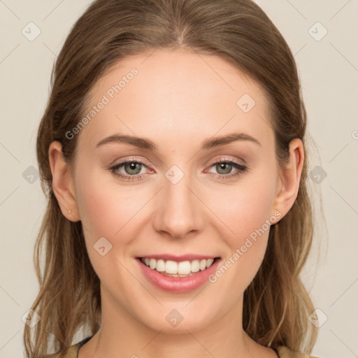 Joyful white young-adult female with long  brown hair and green eyes