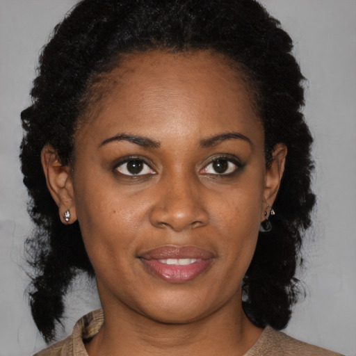 Joyful black young-adult female with medium  brown hair and brown eyes