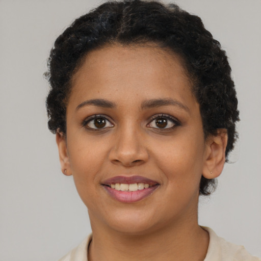 Joyful latino young-adult female with short  brown hair and brown eyes