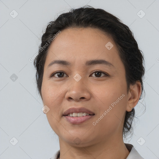 Joyful latino young-adult female with short  black hair and brown eyes