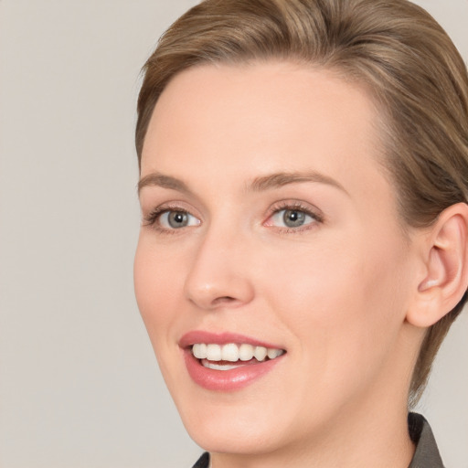 Joyful white young-adult female with medium  brown hair and grey eyes