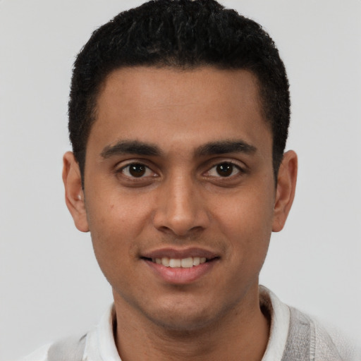 Joyful latino young-adult male with short  brown hair and brown eyes