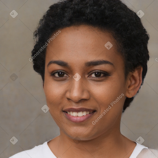 Joyful black young-adult female with short  black hair and brown eyes