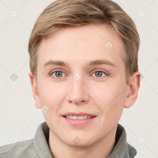 Joyful white young-adult male with short  brown hair and grey eyes