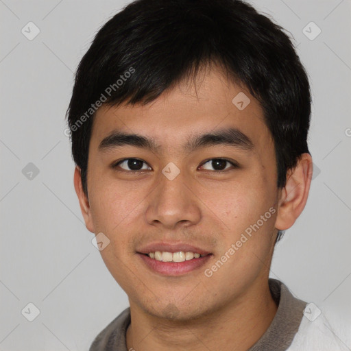 Joyful asian young-adult male with short  black hair and brown eyes