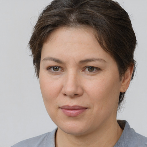 Joyful white adult female with short  brown hair and brown eyes