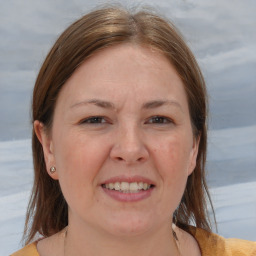 Joyful white adult female with medium  brown hair and brown eyes