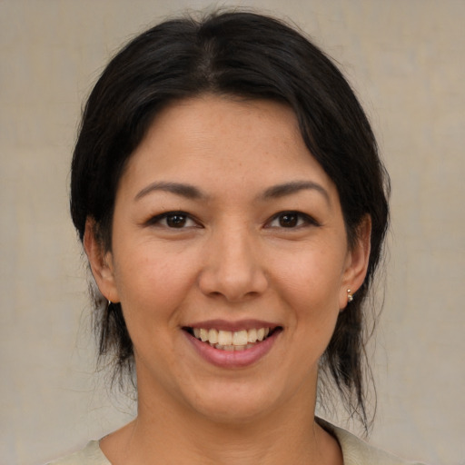 Joyful asian young-adult female with medium  brown hair and brown eyes