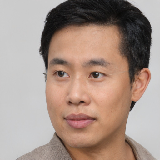 Neutral asian young-adult male with short  black hair and brown eyes