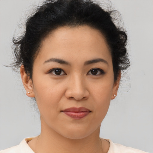 Joyful asian young-adult female with short  brown hair and brown eyes