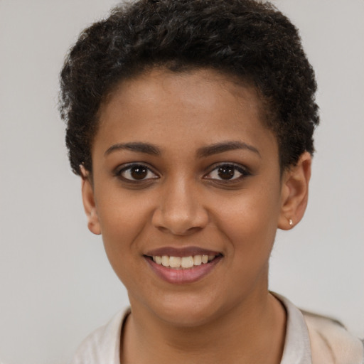Joyful black young-adult female with short  brown hair and brown eyes