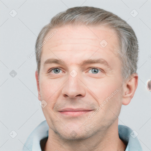 Joyful white adult male with short  brown hair and grey eyes