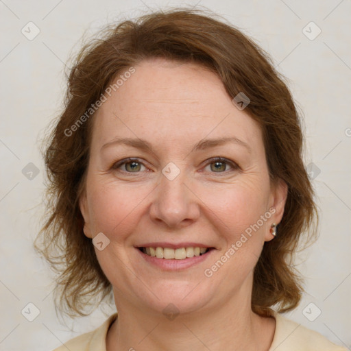 Joyful white adult female with medium  brown hair and green eyes