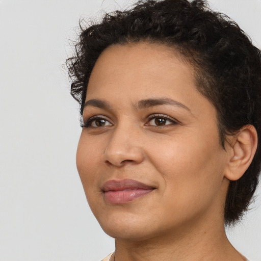 Joyful latino young-adult female with short  brown hair and brown eyes