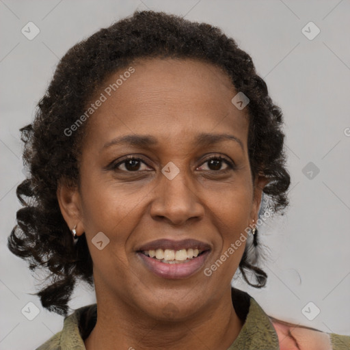 Joyful black adult female with medium  brown hair and brown eyes