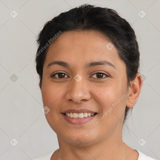 Joyful latino young-adult female with short  brown hair and brown eyes