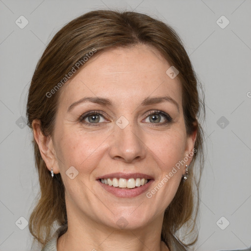 Joyful white adult female with medium  brown hair and grey eyes