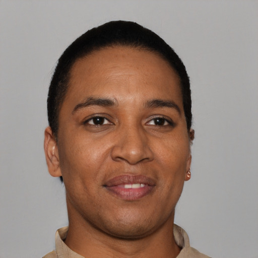 Joyful black young-adult male with short  brown hair and brown eyes