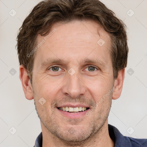 Joyful white adult male with short  brown hair and grey eyes