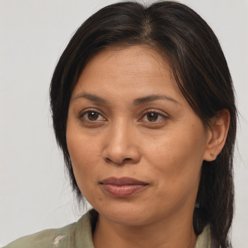 Joyful asian adult female with medium  brown hair and brown eyes