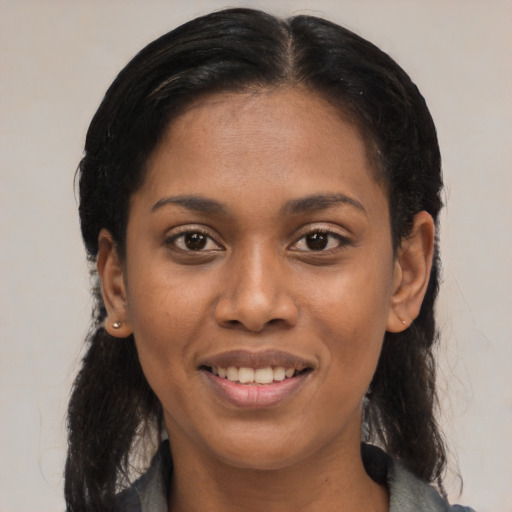 Joyful latino young-adult female with medium  black hair and brown eyes