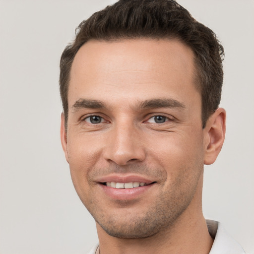 Joyful white young-adult male with short  brown hair and brown eyes