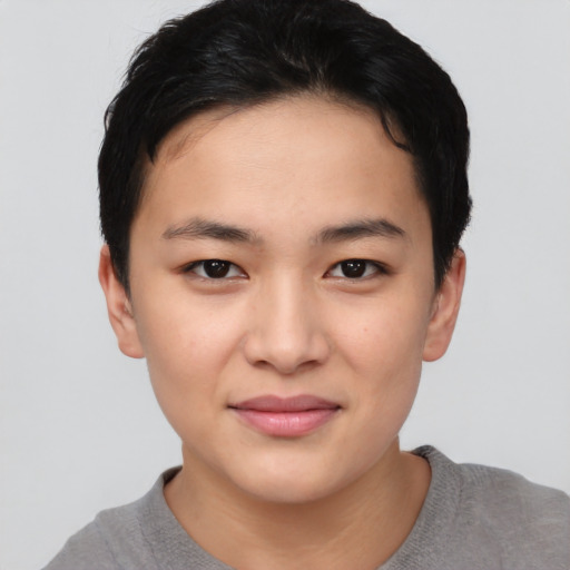 Joyful asian young-adult female with short  black hair and brown eyes