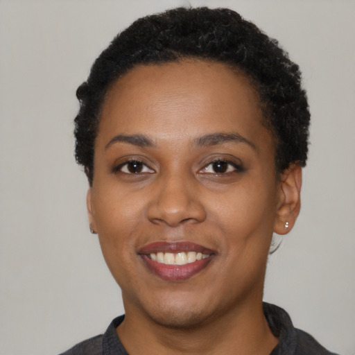 Joyful latino young-adult female with short  black hair and brown eyes