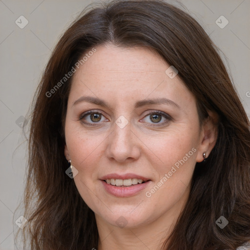 Joyful white adult female with long  brown hair and brown eyes