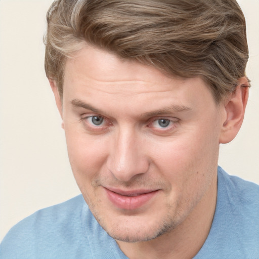 Joyful white adult male with short  brown hair and blue eyes