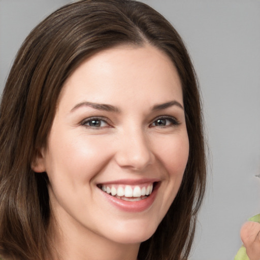 Joyful white young-adult female with medium  brown hair and brown eyes