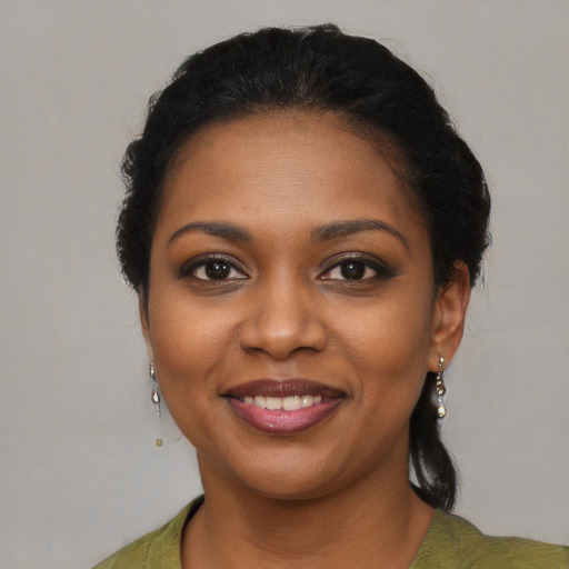 Joyful black young-adult female with medium  brown hair and brown eyes
