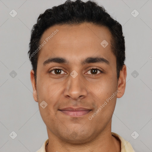 Joyful latino young-adult male with short  black hair and brown eyes