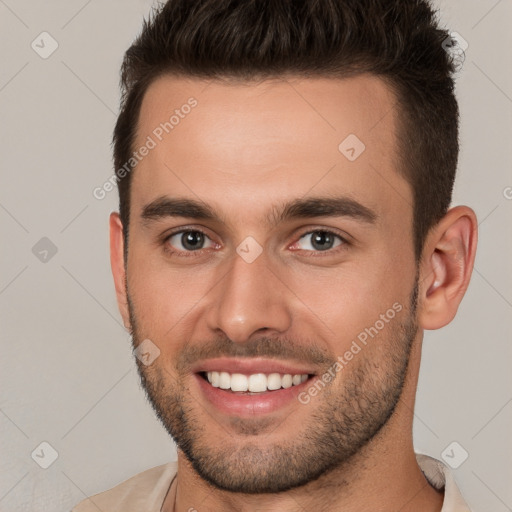 Joyful white young-adult male with short  brown hair and brown eyes