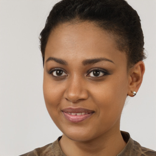 Joyful black young-adult female with short  brown hair and brown eyes