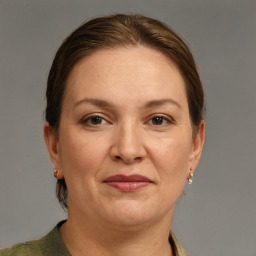 Joyful white adult female with short  brown hair and grey eyes