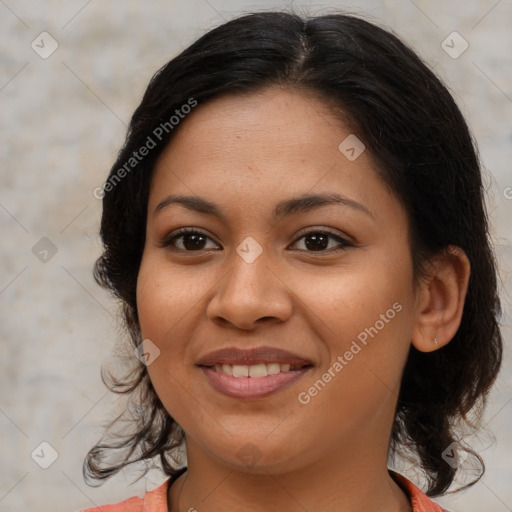 Joyful latino young-adult female with medium  brown hair and brown eyes