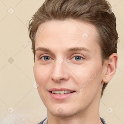 Joyful white young-adult male with short  brown hair and grey eyes