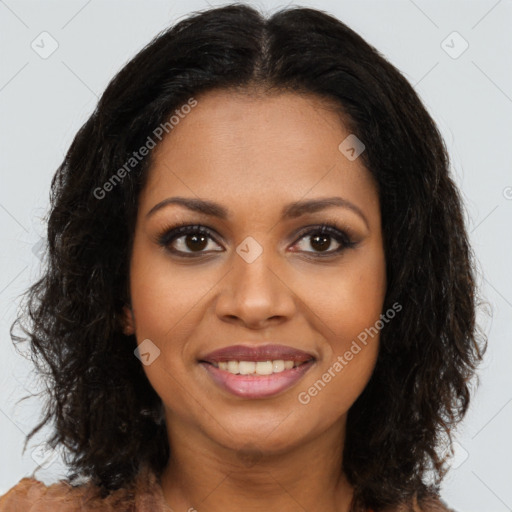 Joyful black young-adult female with long  brown hair and brown eyes