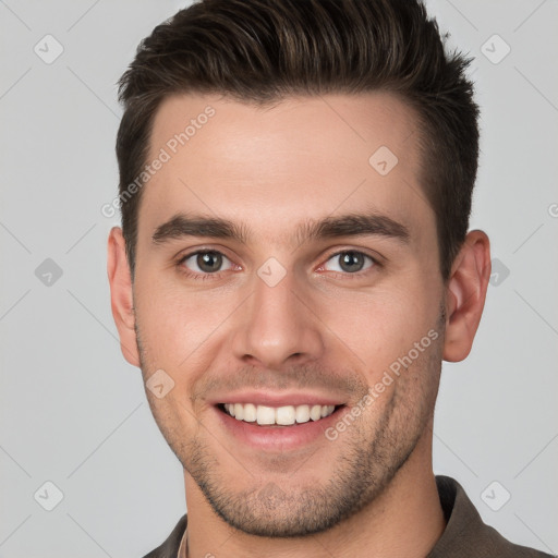 Joyful white young-adult male with short  brown hair and brown eyes