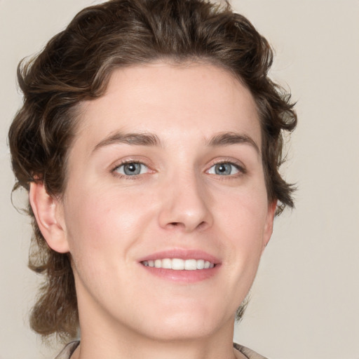 Joyful white young-adult female with medium  brown hair and green eyes