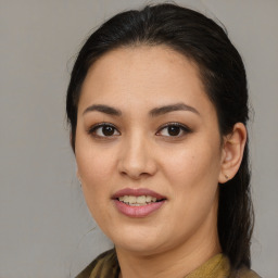 Joyful latino young-adult female with medium  brown hair and brown eyes