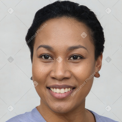 Joyful latino young-adult female with short  black hair and brown eyes