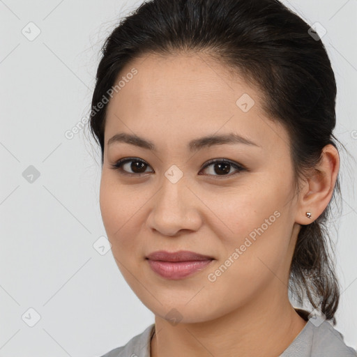 Joyful latino young-adult female with medium  brown hair and brown eyes