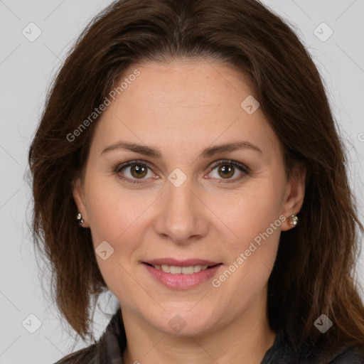 Joyful white adult female with long  brown hair and brown eyes