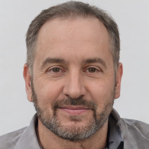 Joyful white adult male with short  brown hair and brown eyes